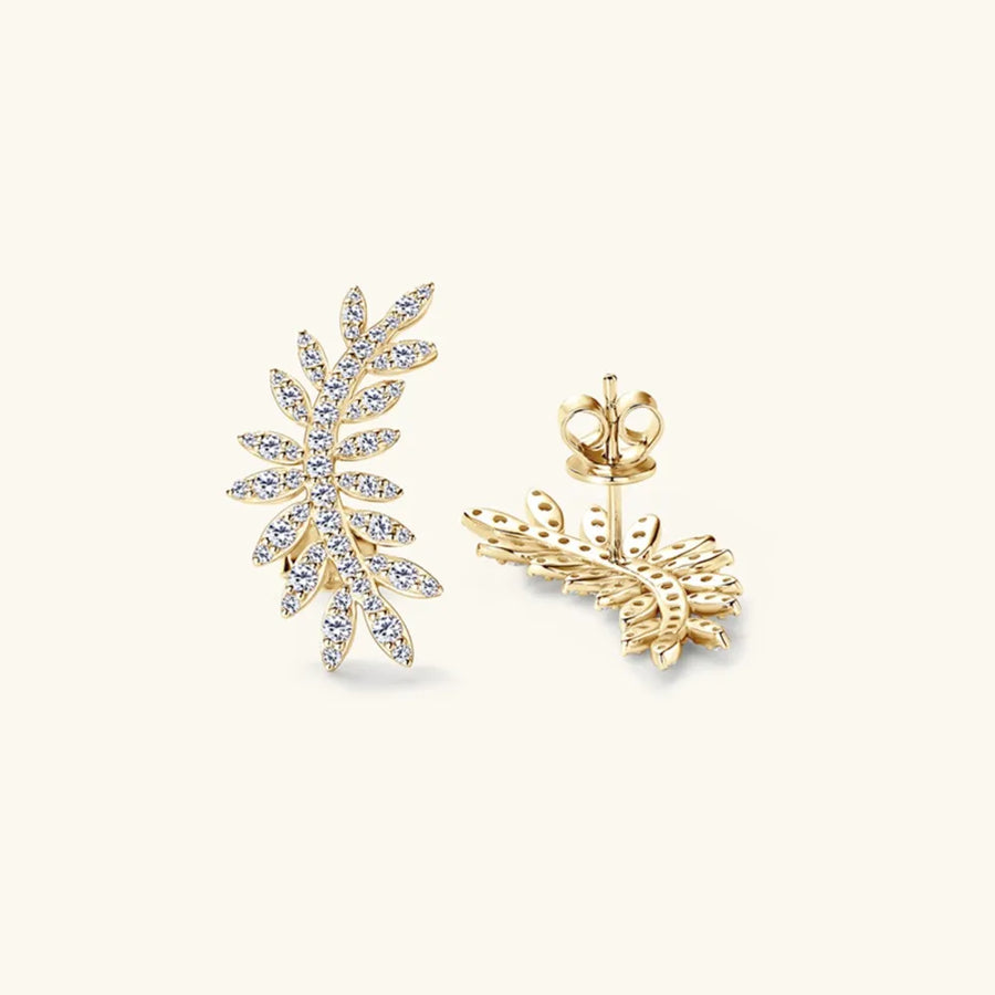 Gold leaf-shaped earrings on a white background