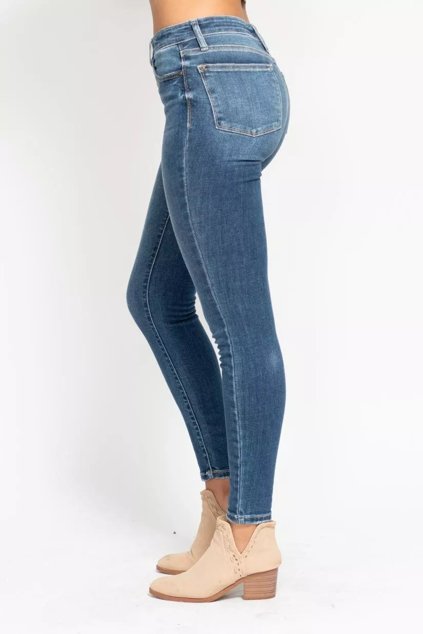 Blue jeans worn by a person on a white background