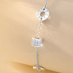 Silver charm with chain on a beige background