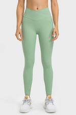 Person wearing green leggings on a white background