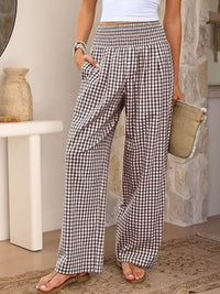 Person wearing checkered pants in a home setting