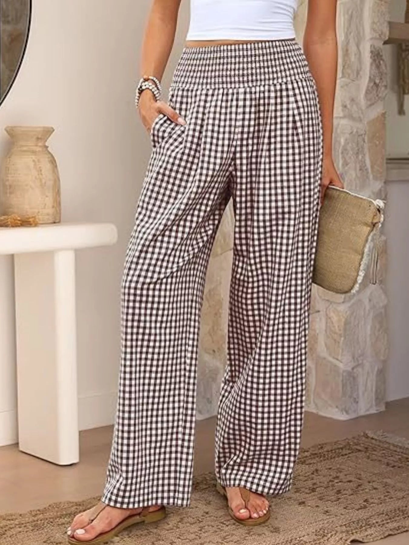 Person wearing checkered pants in a home setting