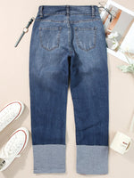 Blue jeans with a color-blocked design on a light background