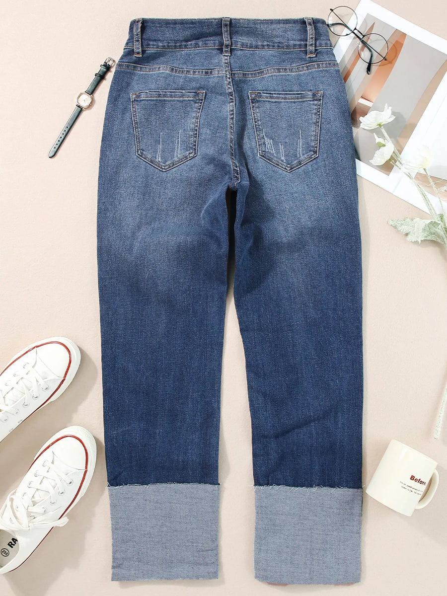 Blue jeans with a color-blocked design on a light background