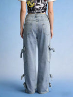 Person wearing light blue cargo pants on a blue background