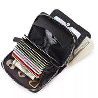Black wallet with various cards, money, and tools on a white background