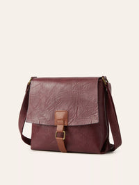 Brown leather crossbody bag on a light beige background