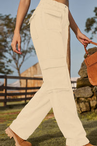 Person wearing beige pants walking outdoors with a rustic background