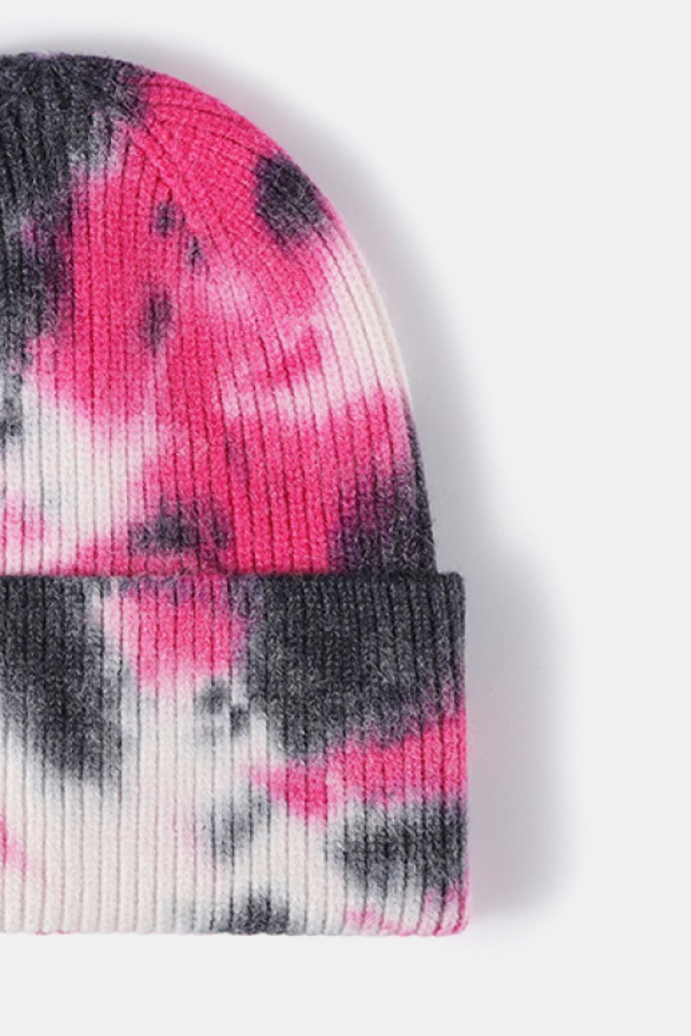 Tie-dye sock with pink, black, and white pattern on a white background