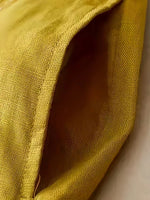 Close-up of a textured yellow fabric with a soft focus background