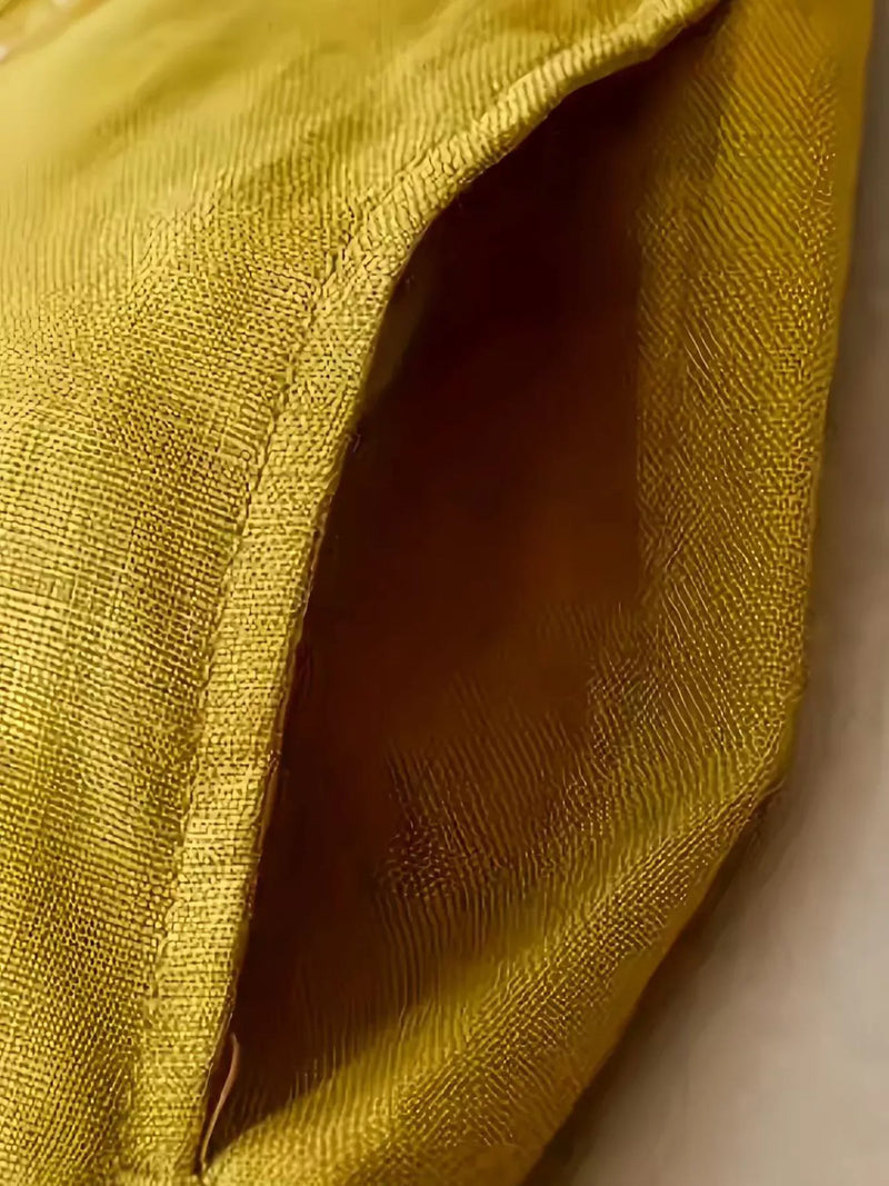 Close-up of a textured yellow fabric with a soft focus background