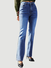 Blue jeans worn by a person on a light gray background