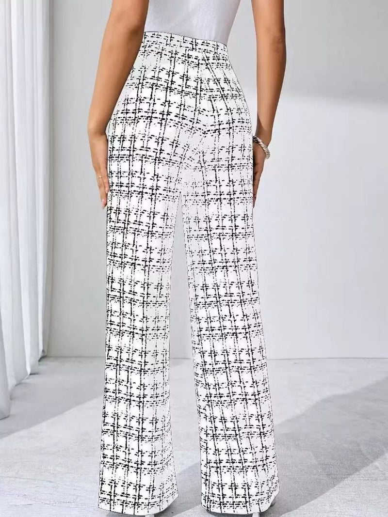 Person wearing black and white checkered pants on a light background