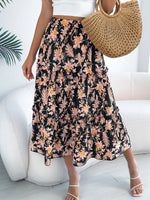Person wearing a floral skirt with a white top and straw bag indoors.