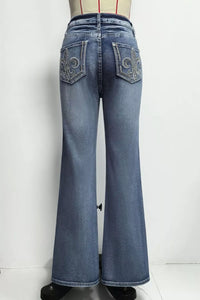 Blue jeans with decorative stitching on a white background