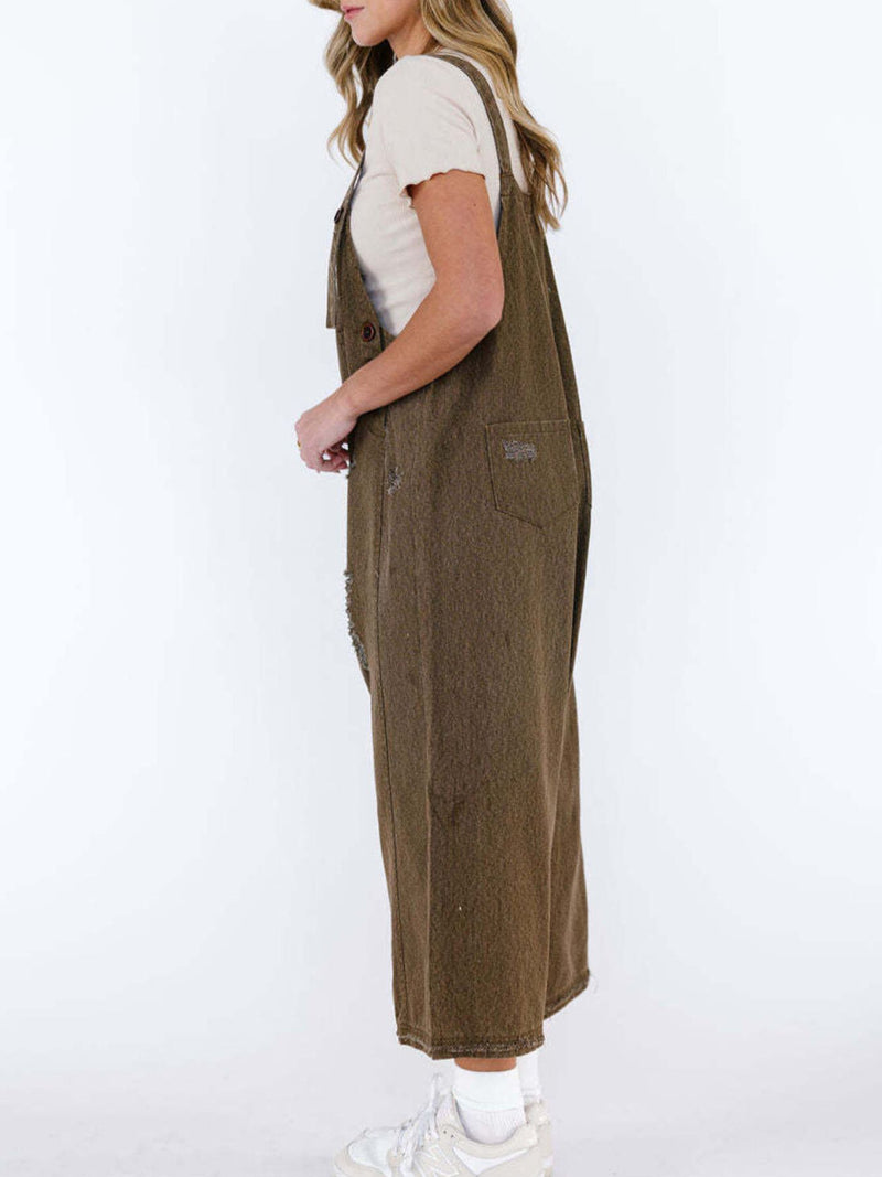 Person wearing brown overalls on a white background