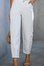 White pants worn by a person against a gray background