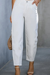 White pants worn by a person against a gray background