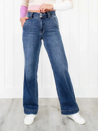 Person wearing blue jeans with a white background