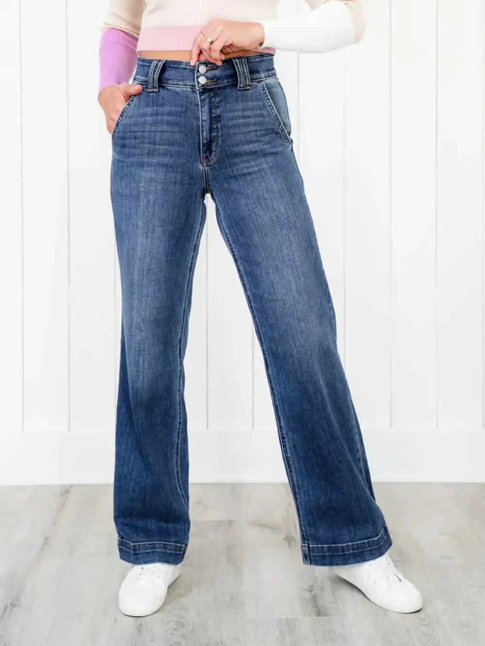 Person wearing blue jeans with a white background