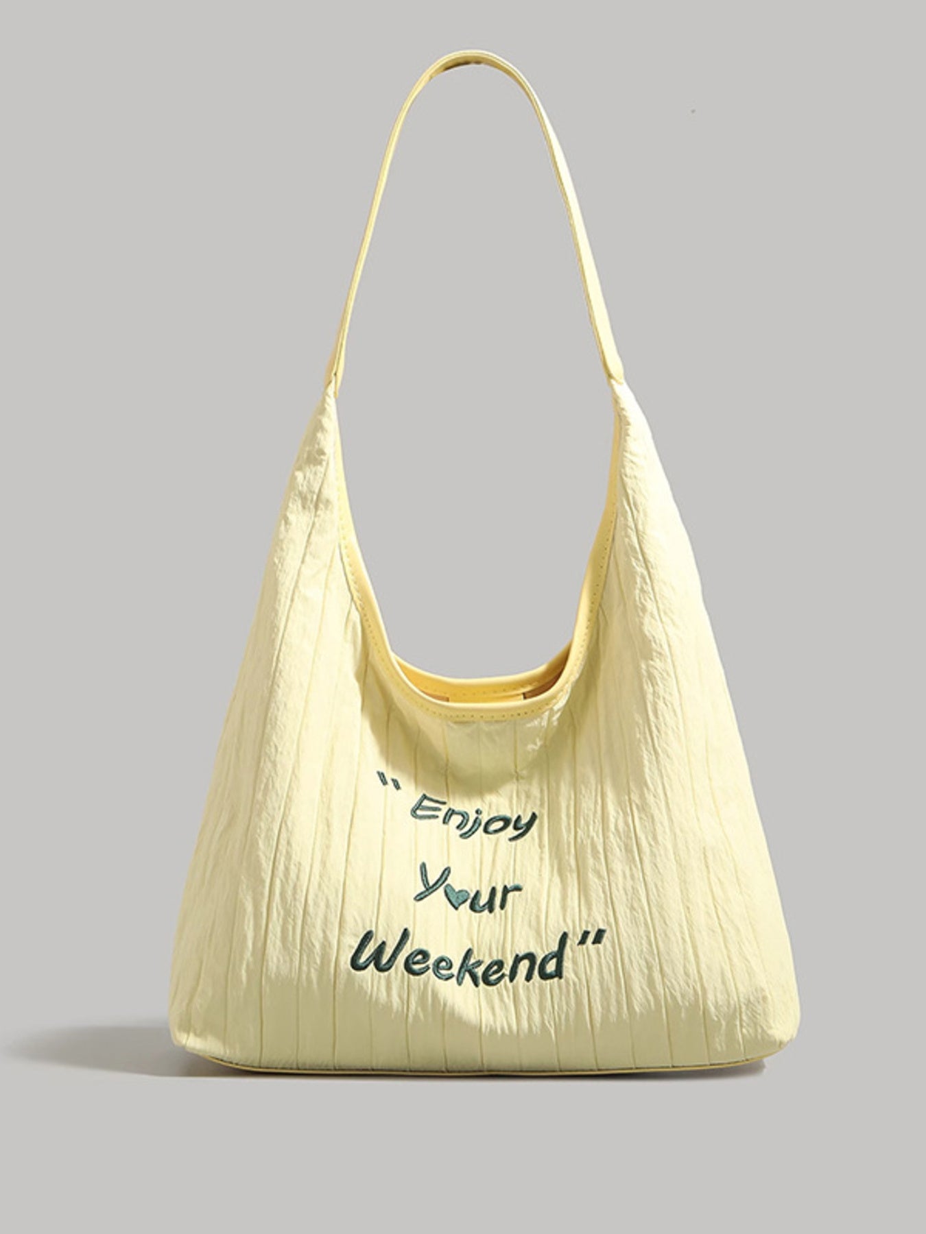 Yellow handbag with 'Enjoy Your Weekend' text on a gray background