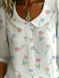 White blouse with floral pattern worn by a person