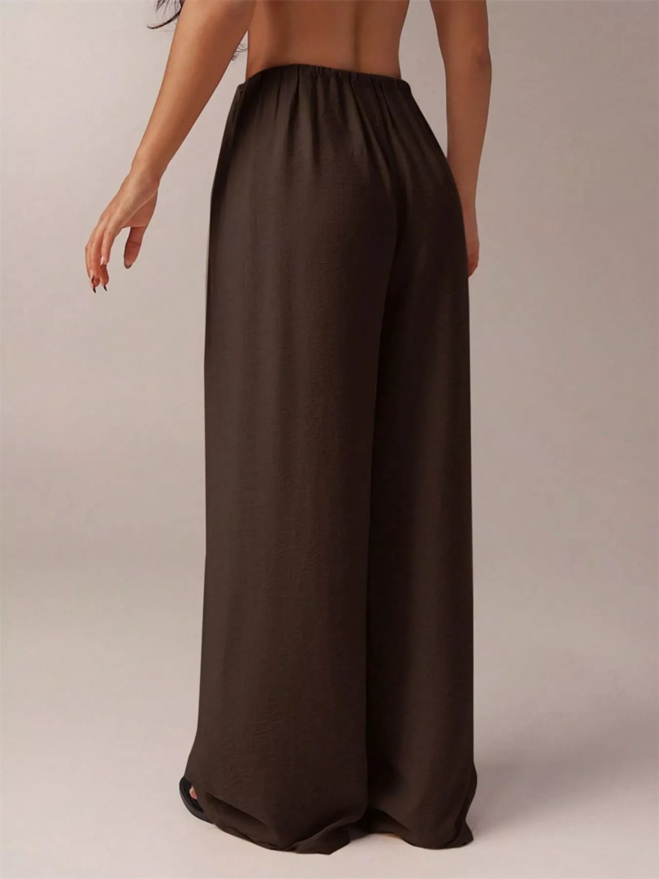 Brown wide-leg pants worn by a person on a plain background