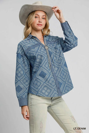 Woman wearing a blue patterned jacket and beige hat on a white background