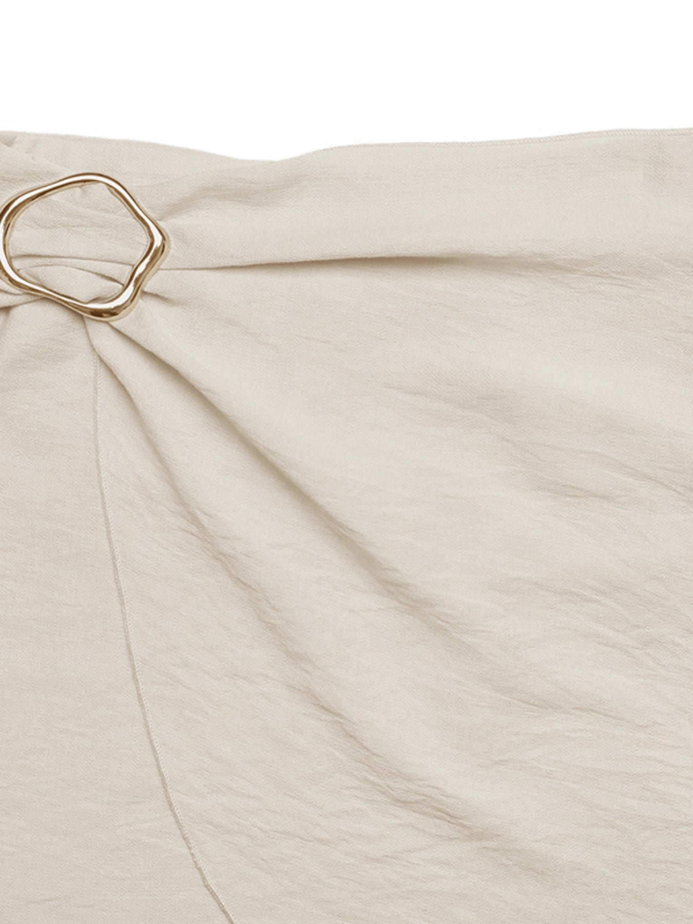 Beige fabric with a gold ring detail on a white background