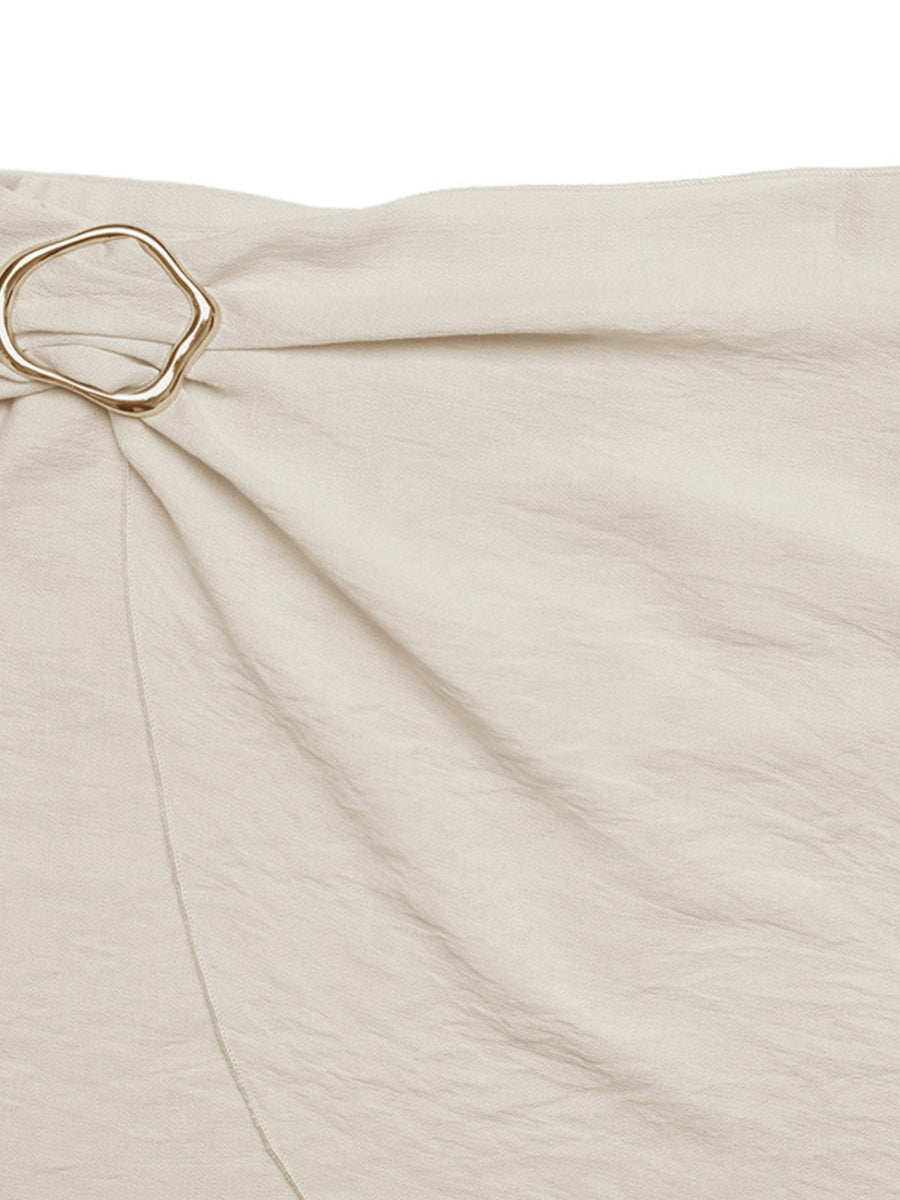 Beige fabric with a gold ring detail on a white background
