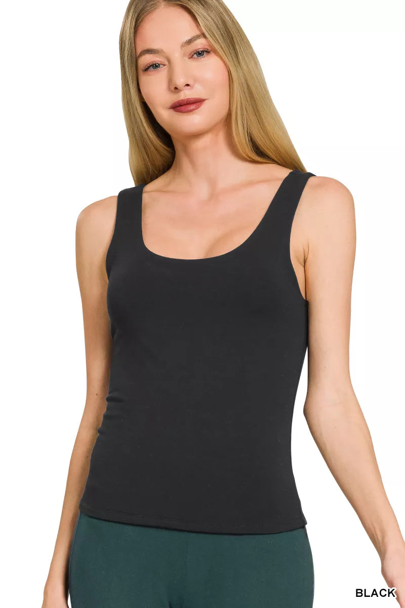 Woman wearing a black tank top on a white background