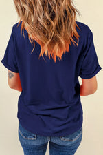 Person wearing a navy blue t-shirt and blue jeans with a neutral background