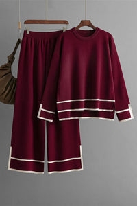 Burgundy outfit with white trim on a gray background