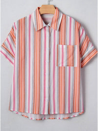 Striped shirt with short sleeves on a hanger against a light gray background