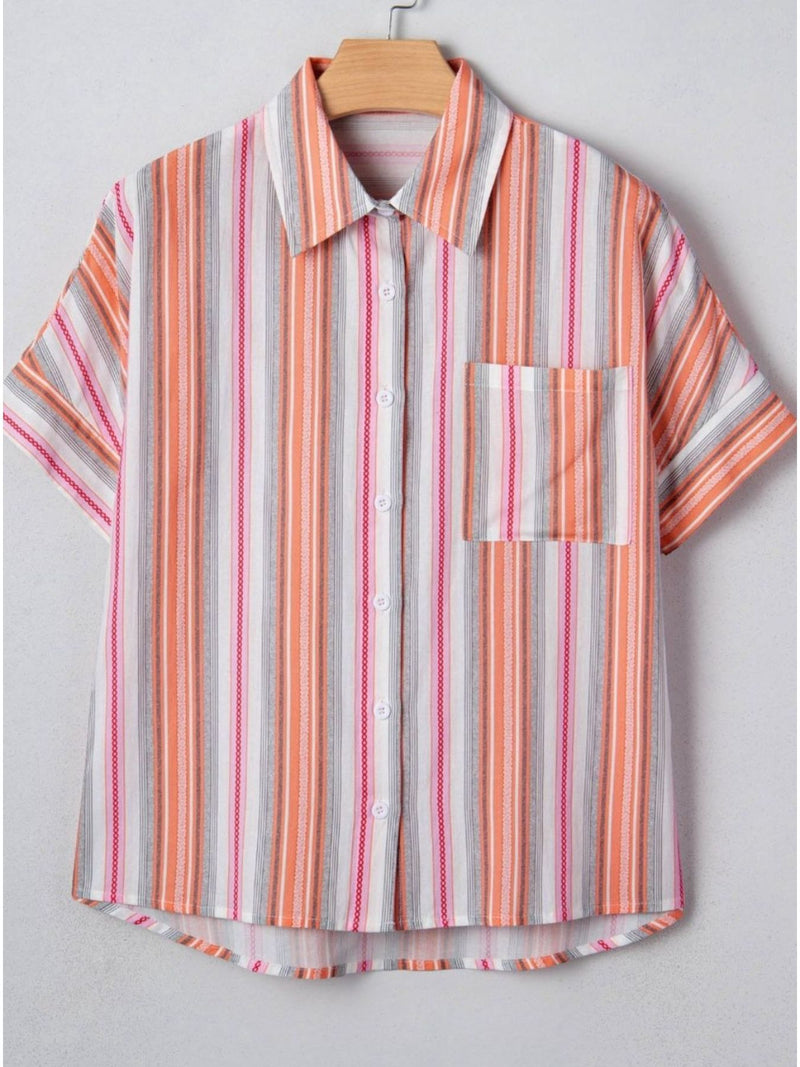 Striped shirt with short sleeves on a hanger against a light gray background