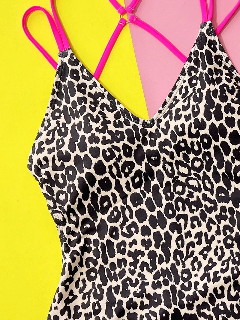 Leopard print swimsuit with pink straps on a yellow background
