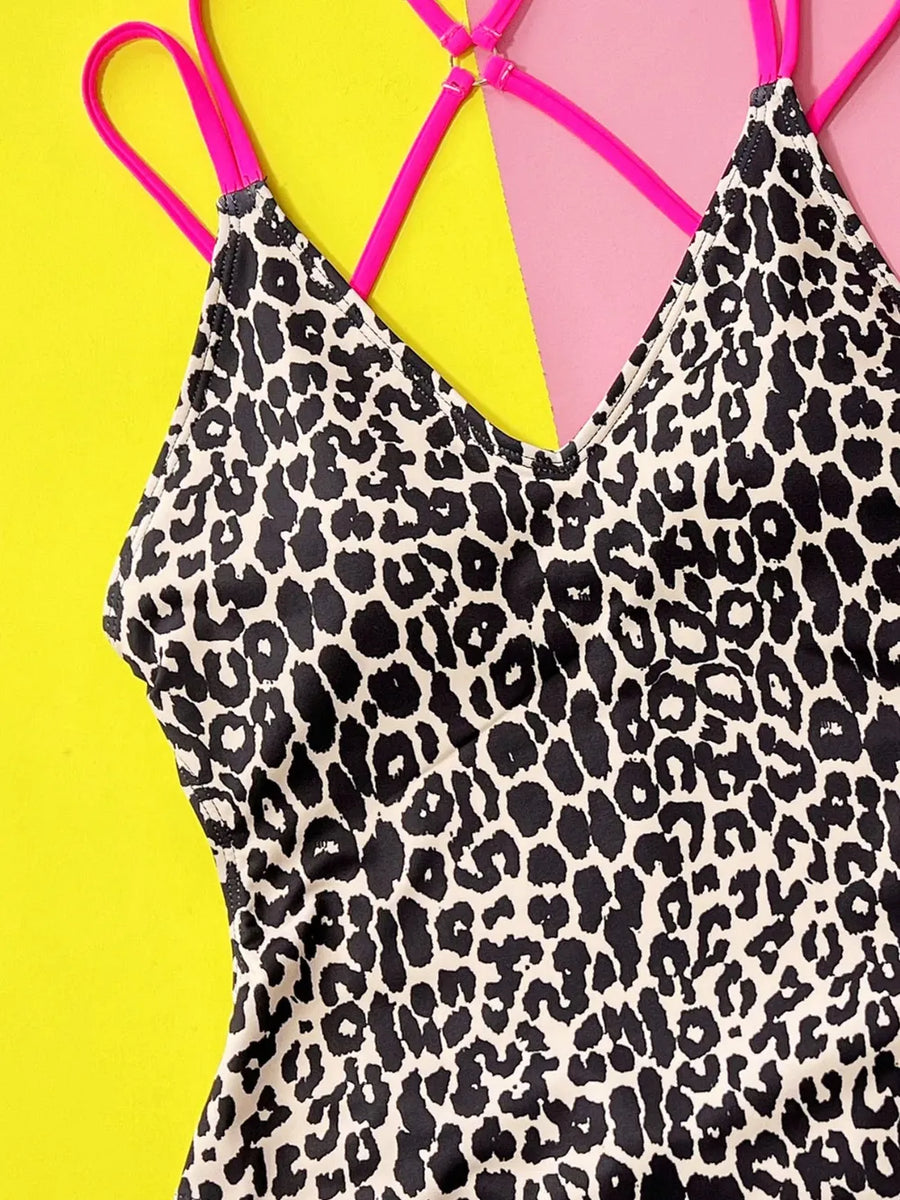 Leopard print swimsuit with pink straps on a yellow background