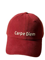 Red cap with 'Carpe Diem' text on a white background