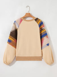 Beige sweatshirt with colorful patterned sleeves on a hanger against a white background