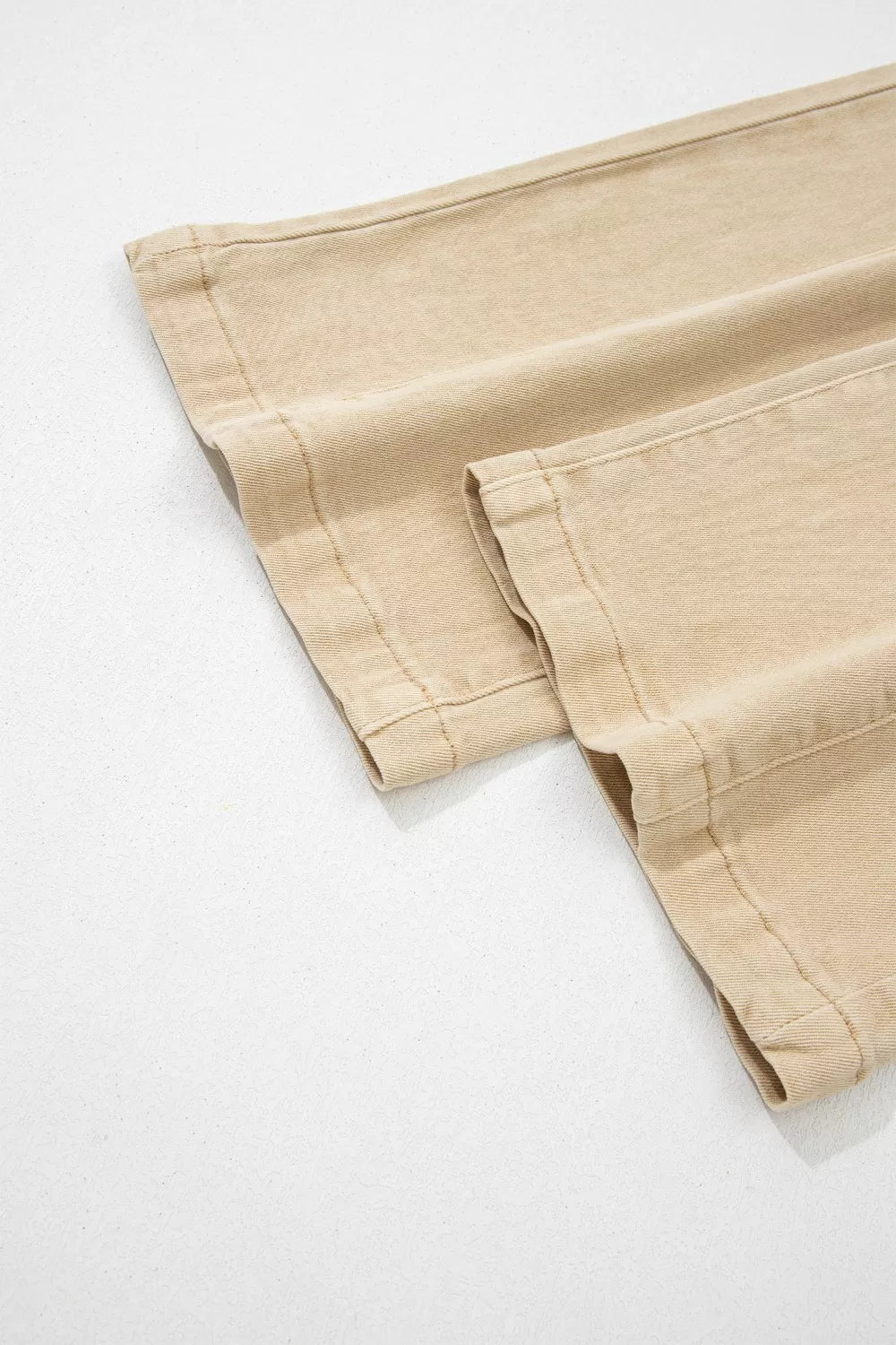 Close-up of beige pants on a white background