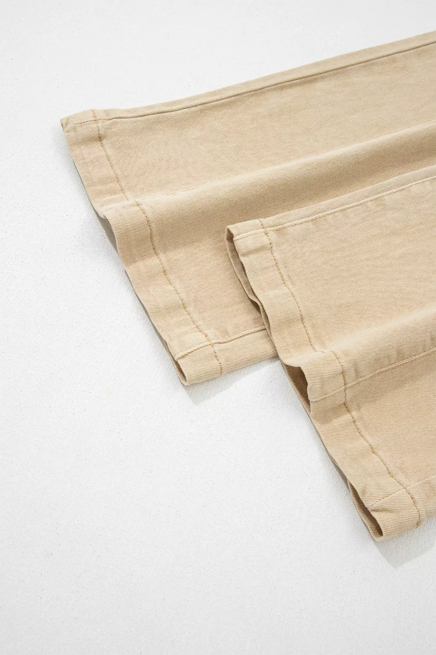 Close-up of beige pants on a white background