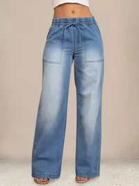 Blue wide-leg jeans on a neutral background