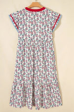 Floral patterned dress on a hanger against a beige background