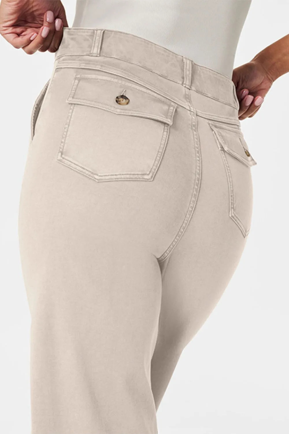 Beige pants with a visible brand logo on a white background