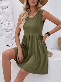 Woman wearing an olive green dress with a white background