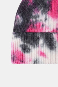 Tie-dye beanie with pink and black patterns on a white background