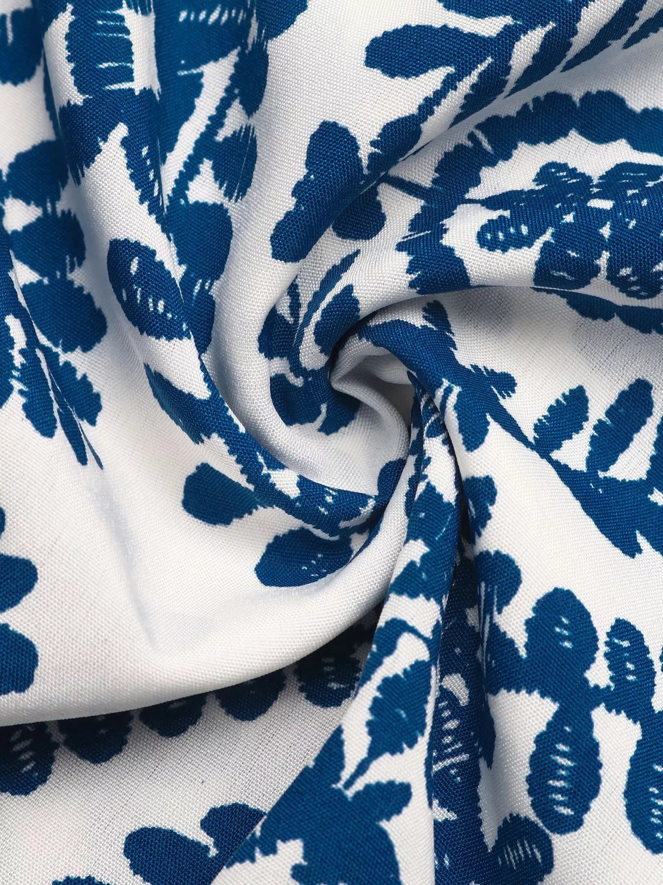 Close-up of blue floral pattern on white fabric