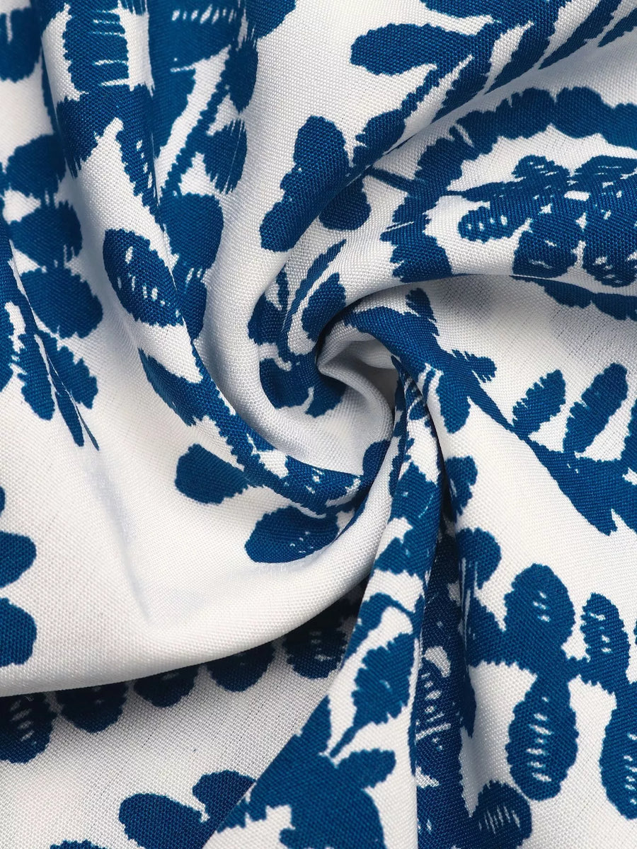 Close-up of blue floral pattern on white fabric