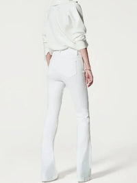 Person wearing a white sweatshirt and white pants on a white background