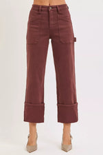 Maroon pants worn by a person on a white background